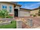 Attractive home featuring brick accents, a two-car garage, and desert landscaping in the front yard at 468 Harvest Rain, Las Vegas, NV 89011