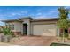 Inviting single-story home with a brick driveway and two-car garage under a clear blue sky at 468 Harvest Rain, Las Vegas, NV 89011