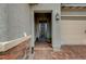 Inviting home entrance with a decorative metal door, brick accents, and tiled walkway at 468 Harvest Rain, Las Vegas, NV 89011