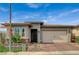 Charming single-story home featuring low maintenance desert landscaping, brick driveway, and a two car garage at 468 Harvest Rain, Las Vegas, NV 89011