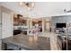 Open-concept kitchen with a large island, dark cabinets, and modern appliances, seamlessly flowing into the living space at 468 Harvest Rain, Las Vegas, NV 89011