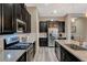 Modern kitchen with stainless steel appliances, dark cabinetry, and a stylish backsplash at 468 Harvest Rain, Las Vegas, NV 89011