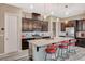 Well-appointed kitchen with stainless appliances, granite counters, and a center island with bar seating at 468 Harvest Rain, Las Vegas, NV 89011