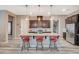 Stylish kitchen features an island with seating, dark wood cabinetry, and stainless steel appliances at 468 Harvest Rain, Las Vegas, NV 89011