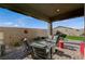 Relaxing covered patio featuring comfortable seating and brick pavers at 468 Harvest Rain, Las Vegas, NV 89011