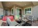 Relaxing covered patio equipped with a hot tub, comfortable seating, and access to the home's interior at 468 Harvest Rain, Las Vegas, NV 89011