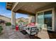 Comfortable covered patio featuring stylish seating, a hot tub, and easy access to the landscaped backyard at 468 Harvest Rain, Las Vegas, NV 89011