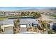 Aerial view of home showcasing mature landscaping, pristine pond, and golf course at 4924 E Cactus Canyon Dr, Pahrump, NV 89061