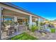 Outdoor living space showcasing a covered patio, dining set, and landscaped backyard at 4924 E Cactus Canyon Dr, Pahrump, NV 89061