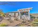 Backyard featuring a fire pit area, covered patio, and low-maintenance landscaping, perfect for outdoor gatherings at 4924 E Cactus Canyon Dr, Pahrump, NV 89061