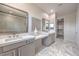 Bright bathroom with double sinks, a glass-enclosed shower, and sleek countertops at 4924 E Cactus Canyon Dr, Pahrump, NV 89061