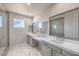 Bright bathroom with double sinks, a glass-enclosed shower, and tile flooring at 4924 E Cactus Canyon Dr, Pahrump, NV 89061