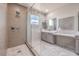 Modern bathroom with a frameless shower, decorative tile, and a dual-sink vanity at 4924 E Cactus Canyon Dr, Pahrump, NV 89061