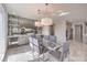 Modern dining room features glass table, gray chairs, stylish lighting, and a mirrored dry bar at 4924 E Cactus Canyon Dr, Pahrump, NV 89061