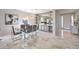 Bright dining area with a glass table, chairs, decorative shelving, and wine refrigerator at 4924 E Cactus Canyon Dr, Pahrump, NV 89061