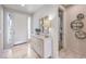 Bright entryway with marble floors, modern console table, decorative mirrors, and access to the bathroom at 4924 E Cactus Canyon Dr, Pahrump, NV 89061