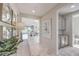 Bright hallway featuring marble floors, art, and an open view into a spacious living room at 4924 E Cactus Canyon Dr, Pahrump, NV 89061