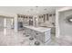 Open concept kitchen with stainless steel appliances, a large island, and a stylish backsplash at 4924 E Cactus Canyon Dr, Pahrump, NV 89061