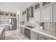 Modern kitchen features gray cabinets, stainless steel appliances, stylish backsplash, and marble-look tile floors at 4924 E Cactus Canyon Dr, Pahrump, NV 89061