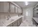 Clean laundry room with plenty of cabinet space, a sink, and a washer and dryer at 4924 E Cactus Canyon Dr, Pahrump, NV 89061
