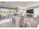 Bright living room with large sliding doors, plush seating, modern decor, and views of the outdoor space at 4924 E Cactus Canyon Dr, Pahrump, NV 89061