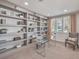 Well-lit home office with custom built-in shelving and a modern glass desk at 4924 E Cactus Canyon Dr, Pahrump, NV 89061