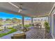 Covered patio with outdoor dining, landscaping, golf course views, and comfortable seating area at 4924 E Cactus Canyon Dr, Pahrump, NV 89061