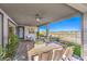 Covered outdoor patio with ceiling fans and outdoor dining area overlooking the backyard at 4924 E Cactus Canyon Dr, Pahrump, NV 89061