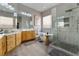 Luxurious bathroom features a freestanding tub, glass shower, and double sink vanity with ample counter space at 4996 Del Pueblo Ave, Las Vegas, NV 89141