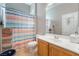 Bright bathroom showcasing a vanity with ample counter space and a colorful shower curtain at 4996 Del Pueblo Ave, Las Vegas, NV 89141