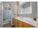 Modern bathroom features a vanity with a large mirror and a glass-enclosed shower at 4996 Del Pueblo Ave, Las Vegas, NV 89141