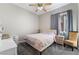 Cozy bedroom featuring a floral patterned comforter, ceiling fan, and soft carpet at 4996 Del Pueblo Ave, Las Vegas, NV 89141