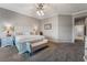 Spacious bedroom with gray carpet, a ceiling fan, and a white bed frame with a matching bench at 4996 Del Pueblo Ave, Las Vegas, NV 89141