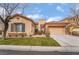 Inviting single-Gathering home showcasing a stucco exterior, two-car garage, and neatly kept landscaping at 4996 Del Pueblo Ave, Las Vegas, NV 89141