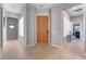 Welcoming foyer features neutral tile floors and a solid natural wood front door with an open view to living spaces at 4996 Del Pueblo Ave, Las Vegas, NV 89141