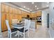 Open concept kitchen with dining nook and gorgeous, custom wood cabinets at 4996 Del Pueblo Ave, Las Vegas, NV 89141