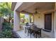 Relaxing covered patio complete with a dining area, garden bed, and ceiling fan at 4996 Del Pueblo Ave, Las Vegas, NV 89141