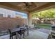 Charming covered patio featuring a dining set, bench, and grill for outdoor enjoyment at 4996 Del Pueblo Ave, Las Vegas, NV 89141