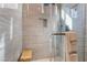 Modern shower with beige tiling, a glass door, and a convenient shower niche at 4996 Del Pueblo Ave, Las Vegas, NV 89141