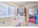Bathroom area featuring a tub, shower, and doorway leading to the bedroom at 5024 Granite Creek Ct, Las Vegas, NV 89131