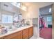 Bathroom with double sinks, vanity, large mirror, and access to the closet at 5024 Granite Creek Ct, Las Vegas, NV 89131