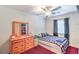Bedroom featuring a bed, dresser with a mirror, and a ceiling fan at 5024 Granite Creek Ct, Las Vegas, NV 89131