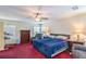 Bedroom with a bed, dresser, recliner chair, ceiling fan, and window views at 5024 Granite Creek Ct, Las Vegas, NV 89131