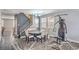 The dining room features a round table with seating, a modern chandelier, and a workout machine at 5024 Granite Creek Ct, Las Vegas, NV 89131