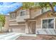 Inviting two-story home features a two-car garage and desert landscaping at 5024 Granite Creek Ct, Las Vegas, NV 89131