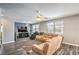 Spacious living room features hardwood floors, a large sectional sofa, ceiling fans, and large windows at 5024 Granite Creek Ct, Las Vegas, NV 89131