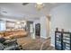 Wide angle view of a spacious living room with hardwood floors, a large sectional sofa, and access to the kitchen at 5024 Granite Creek Ct, Las Vegas, NV 89131