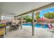Back patio featuring a refreshing pool, outdoor seating, and a well-maintained patio area at 5024 Granite Creek Ct, Las Vegas, NV 89131