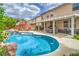 Resort-style backyard features a sparkling pool, spa, covered patio and lush landscaping at 5024 Granite Creek Ct, Las Vegas, NV 89131