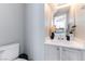 Elegant half-bathroom with modern sink and decor, connected to the kitchen at 509 Chestnut View Pl, Henderson, NV 89052
